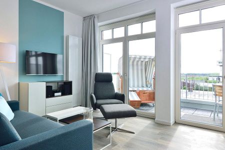 Aparthotel Anna Düne Aparthotel Anna Düne 2-30 Wangerooge - Wohn/ Essbereich mit Couch, Sessel und Fernseher