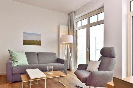 Aparthotel Anna Düne Aparthotel Anna Düne 2-37 Wangerooge - Wohn/ Essbereich mit Couch, Sessel und Tisch