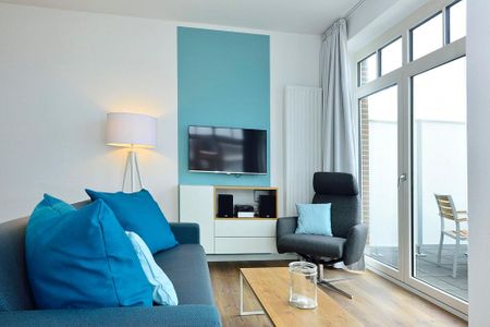 Aparthotel Anna Düne Aparthotel Anna Düne 2-38 Wangerooge - Wohn/ Essbereich mit Couch, Sessel und Fernseher