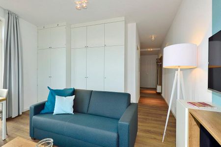 Aparthotel Anna Düne Aparthotel Anna Düne 2-38 Wangerooge - Wohn/ Essbereich mit Couch