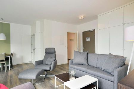Aparthotel Anna Düne Aparthotel Anna Düne 2-39 Wangerooge - Wohn/ Essbereich mit Couch, Sessel und Tisch