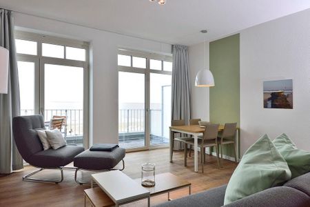 Aparthotel Anna Düne Aparthotel Anna Düne 1-23 Wangerooge - Wohn/ Essbereich mit Sessel