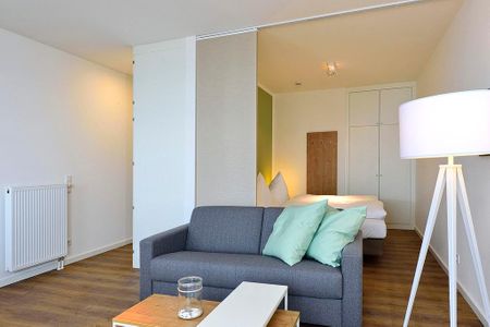 Aparthotel Anna Düne Aparthotel Anna Düne 1-23 Wangerooge - Wohn/ Essbereich mit Couch