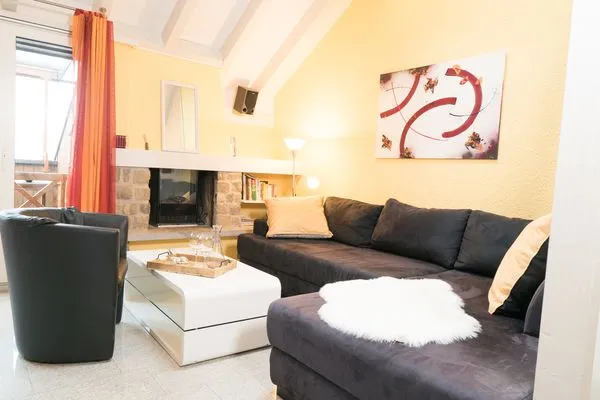 Livingroom with couch and cheminée  Apartment Hinterberg