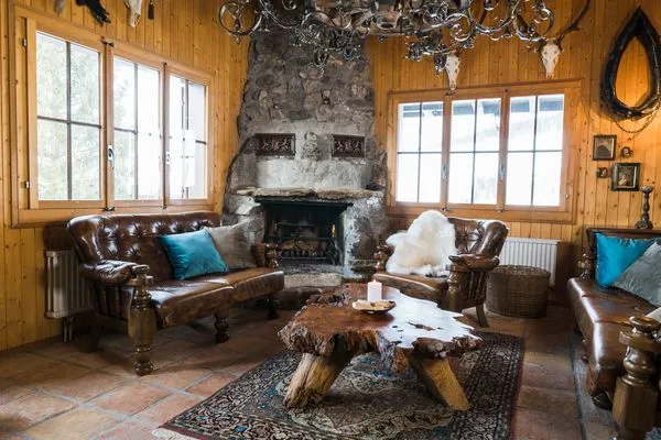 Rustically furnished living room with a fireplace  Chalet Theresia