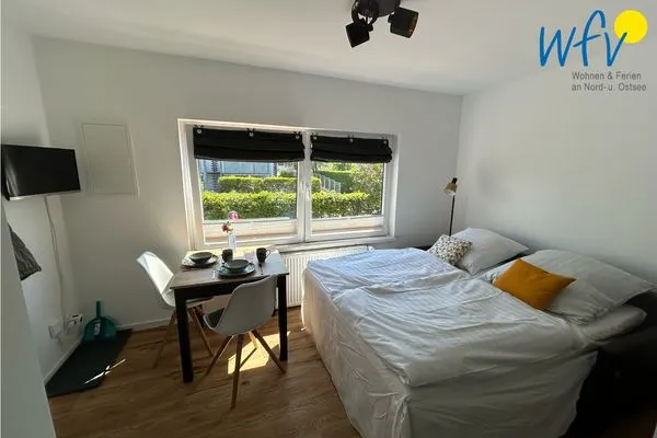 Wohnzimmer mit ausgeklapptem Schlafsofa Haus Rinelde Ferienwohnung "Deck 1"