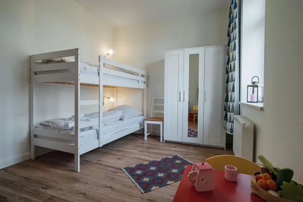 Schlafzimmer mit Etagenbett und Spielbereich  Ferienwohnung Gut Hardesby