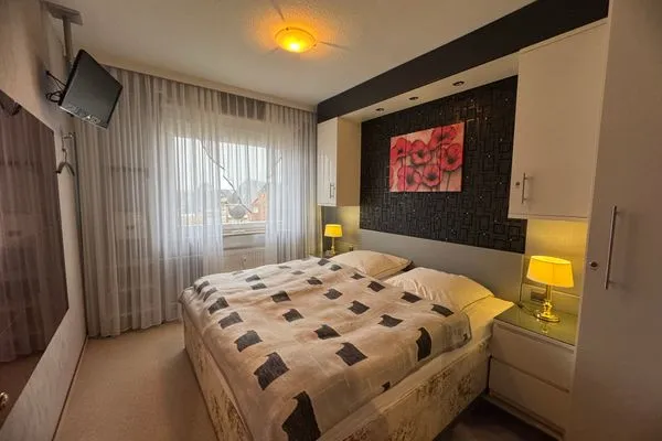 Schlafzimmer mit TV Ferienwohnung im Haus Nordland App 44