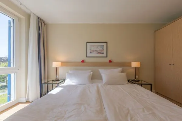 Ferienwohnung Herzmuschel Aparthotel Zingst - gemütliches Doppelbett im Schlafzimmer  Herzmuschel