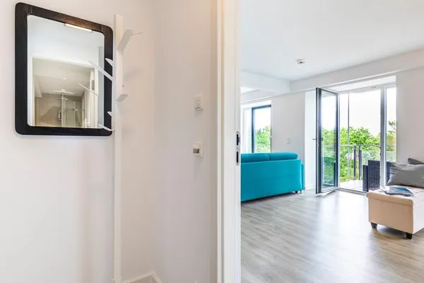 Wohnzimmer: Schlafcouch, TV, Essbereich, Zugang zum Balkon  FeWo Dünenwald in PRORA - 6.44