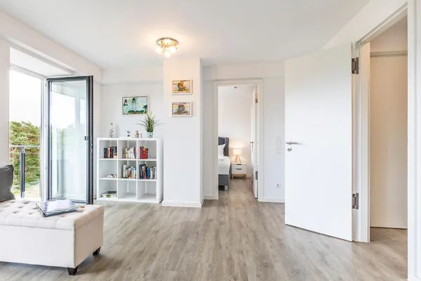 Wohnzimmer: Schlafcouch, TV, Essbereich, Zugang zum Balkon  FeWo Dünenwald in PRORA - 6.44