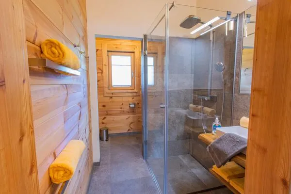Bathroom 1, shower and toilet  Chalet Huber by Alpenidyll Apartments