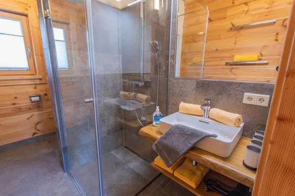 Bathroom 1, shower and toilet  Chalet Huber by Alpenidyll Apartments