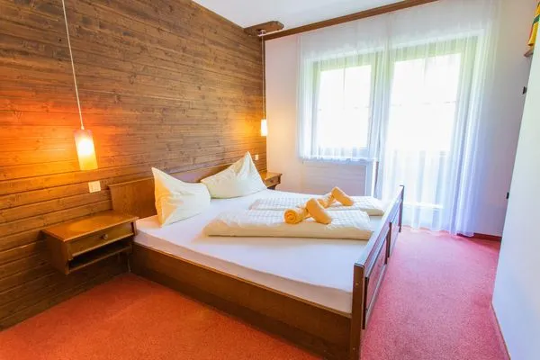 Doppelbett mit Zugang Balkon  Huberhof 4 by Alpenidyll Apartments