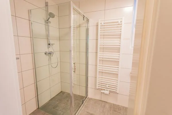 Bathroom with toilet and shower  Sunny Aich by Alpenidyll Apartments