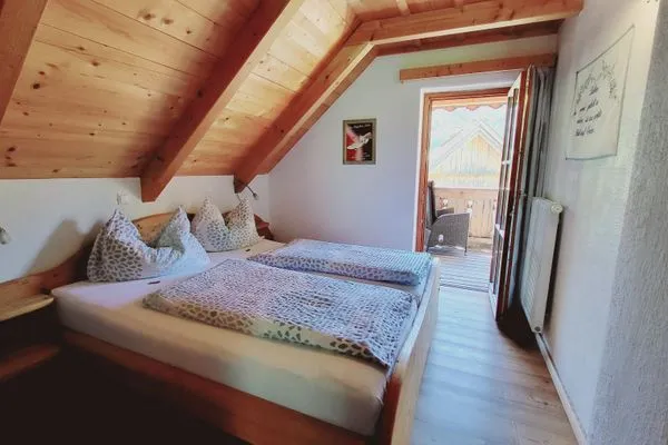 Bedroom 1, double bed, and access to the balcony  Stodertraum 1 "Vergissmeinnicht" by Alpenidyll Apartments