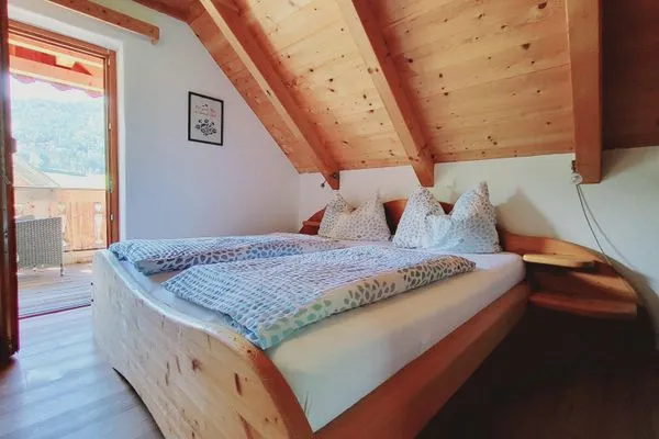 Bedroom 2, double bed, and access to the balcony  Stodertraum 3 "Löwenzahn" by Alpenidyll Apartments