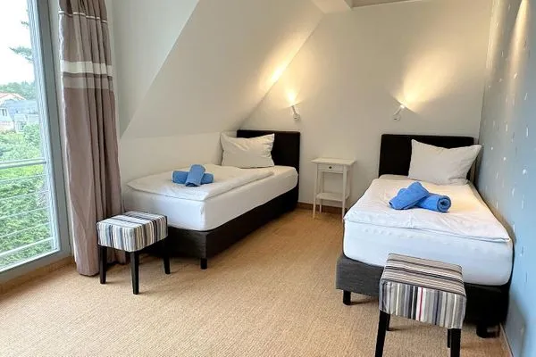 zweites Schlafzimmer mit zwei Einzelbetten, Schrank und Schminktisch  Achternhus Kalle