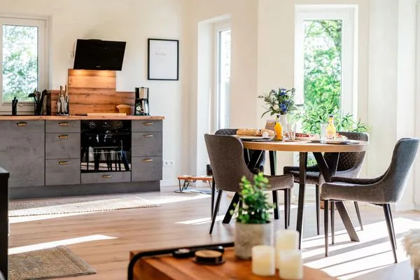 Großzügiger Wohnraum mit Essbereich, Küche, Kamin und Sofa  Fördezauber