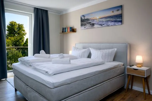 Schlafzimmer  FeWo Tag am Meer - Kamin, Sauna, Meerblick