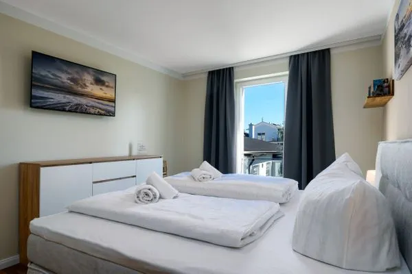 Schlafzimmer  FeWo Tag am Meer - Kamin, Sauna, Meerblick
