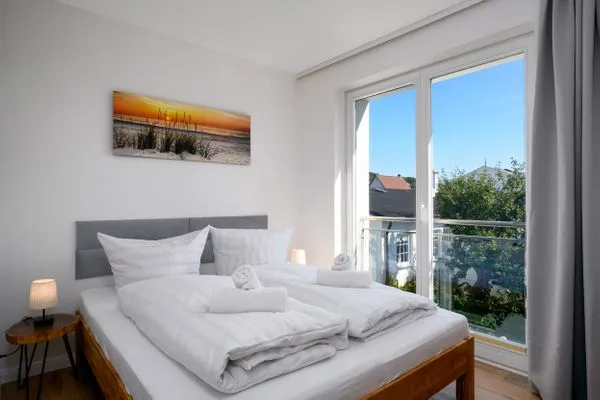 Schlafzimmer  FeWo Tag am Meer - Kamin, Sauna, Meerblick