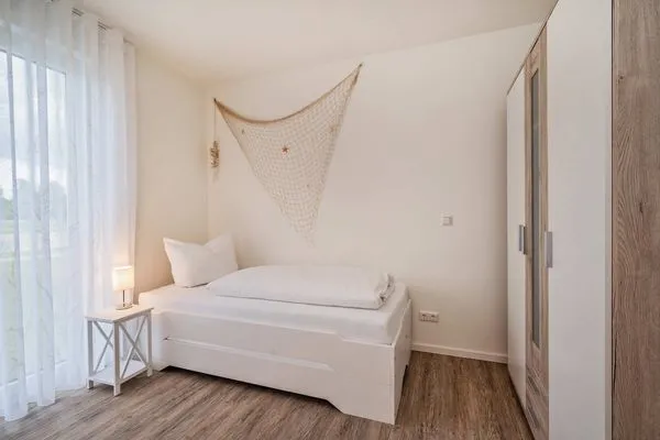 Schlafzimmer  Ferienwohnung Klippenblick mit Sauna, Kinderspielbereich und Fitnessraum