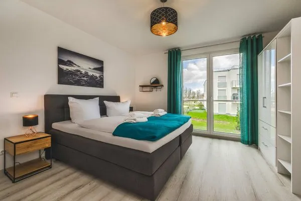 Schlafzimmer  Ferienwohnung Meerzeit mit Sauna, Balkon und Wellnessbereich