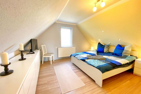 Schlafzimmer 1 mit Doppelbett und TV