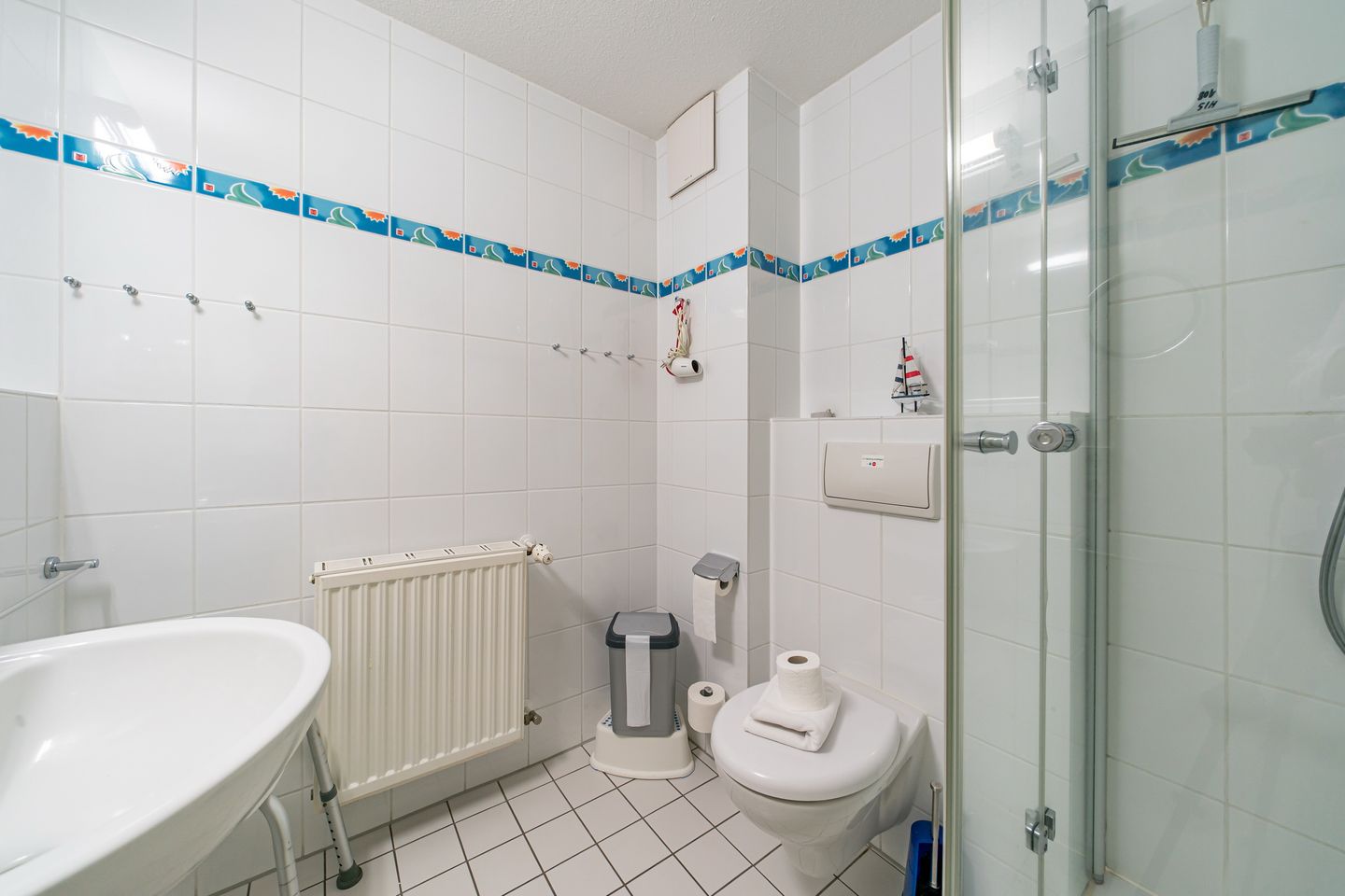 Hus Inselkieker Hus Inselkieker 108 Schillig - Badezimmer mit WC, Waschtisch und Spiegel