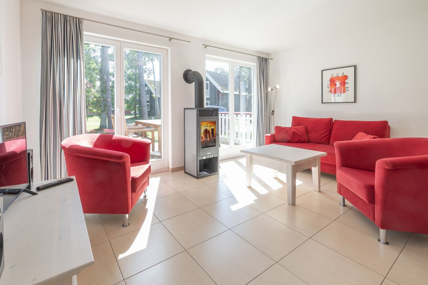 Ostseepark Rügen Ostseepark Rügen 25 Rügen - Wohn-Essbereich mit Couch, Kamin und Zugang zur Terrasse