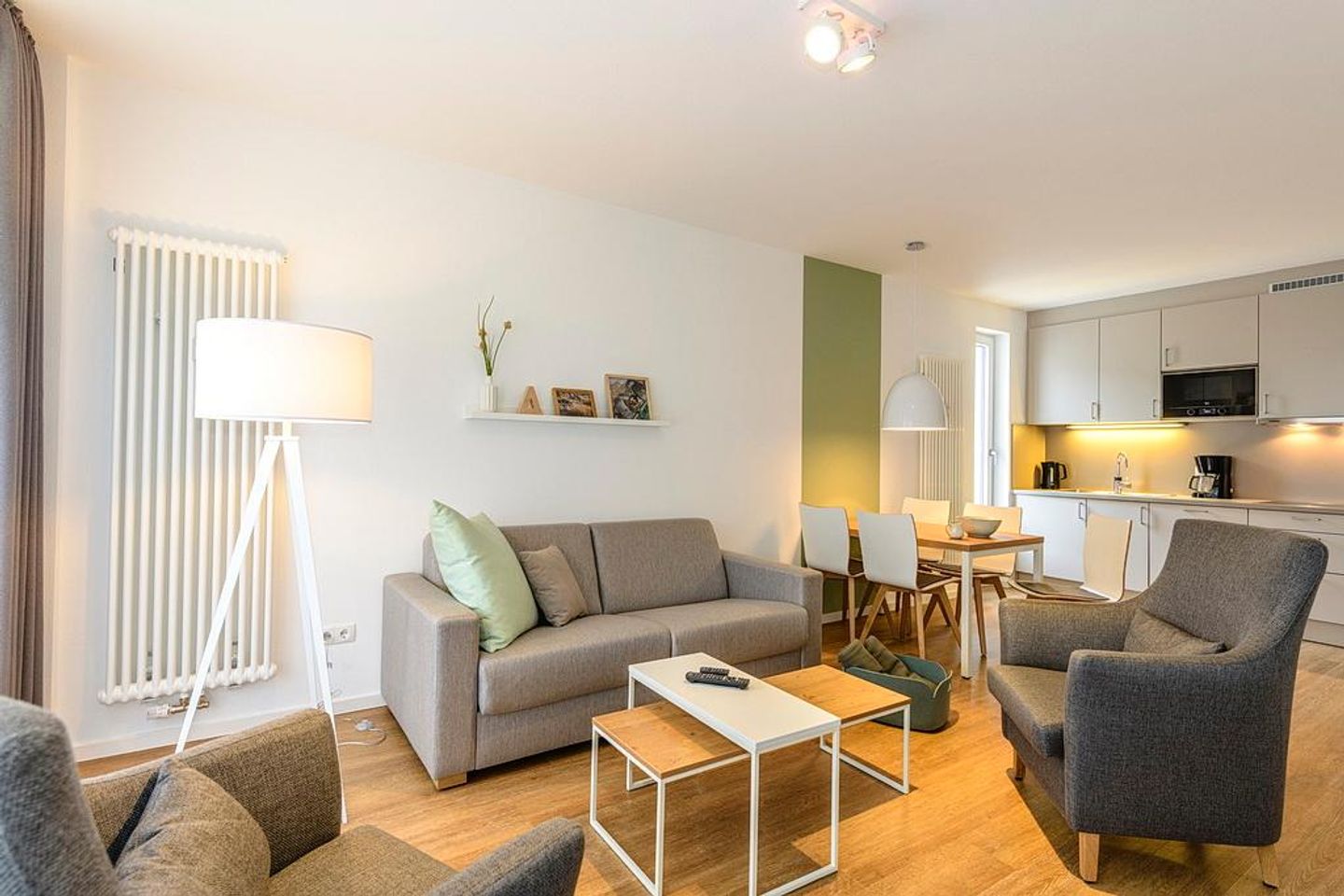 Deichhäuser Anna Küste Deichhäuser Anna Küste 1-10 Bensersiel - Wohn/Essbereich mit Sesseln, Couch,  Esstisch und Küchenzeile