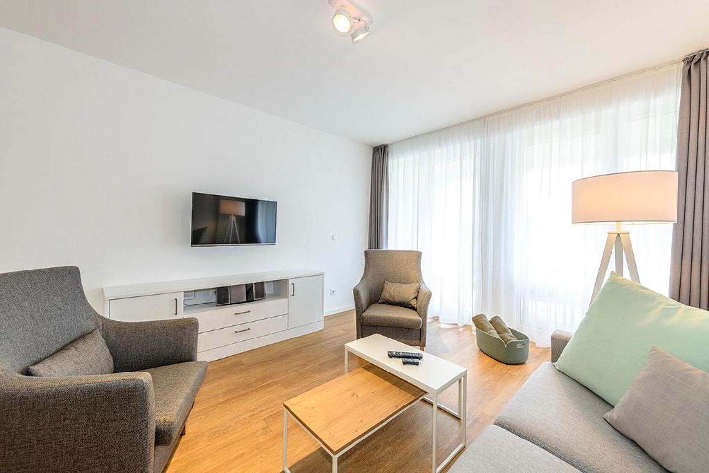 Deichhäuser Anna Küste Deichhäuser Anna Küste 1-10 Bensersiel - Wohn/Essbereich mit Sesseln, Couch und TV