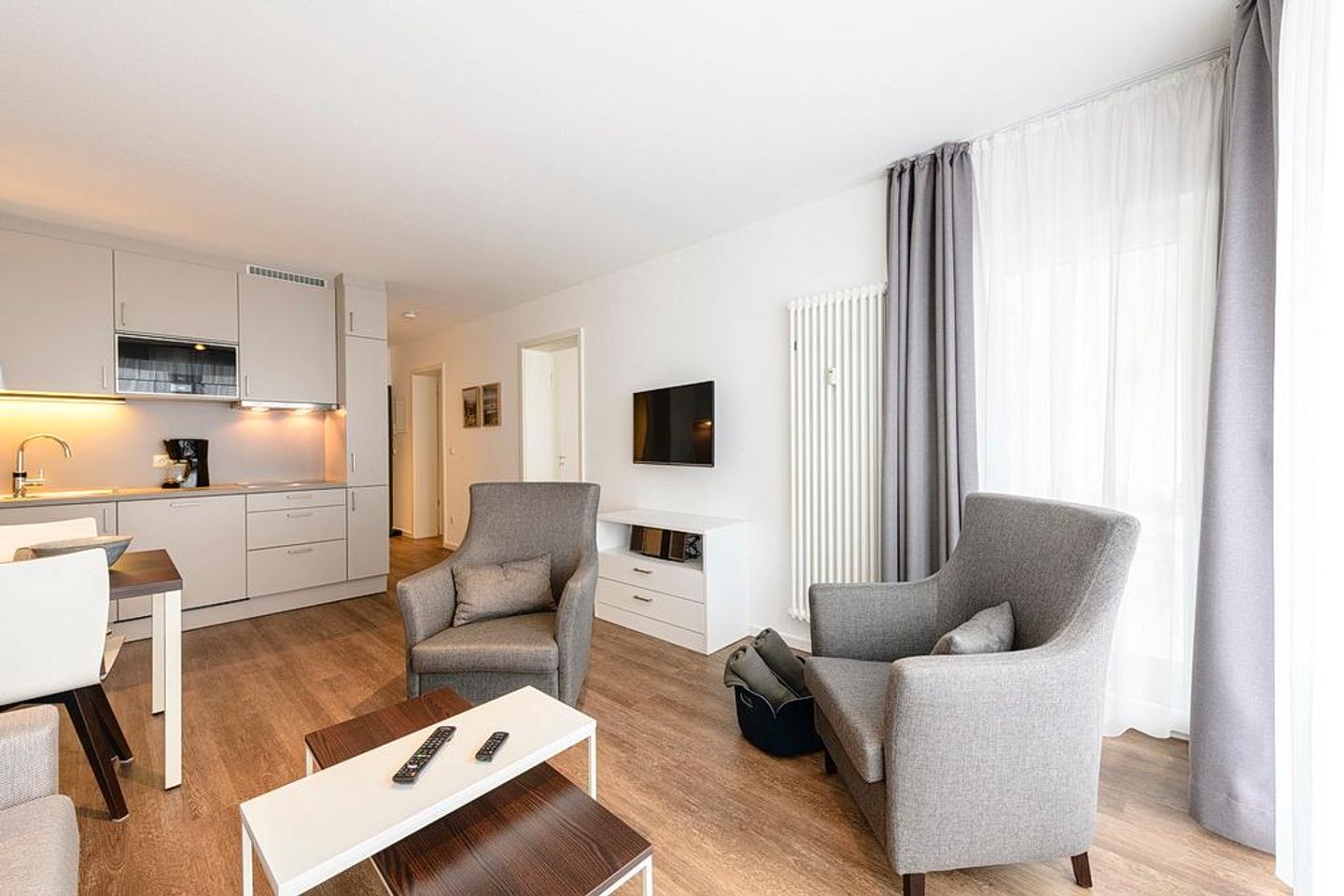 Deichhäuser Anna Küste Deichhäuser Anna Küste 1-24 Bensersiel - Wohn/Essbereich mit Sesseln, TV und Küchenzeile