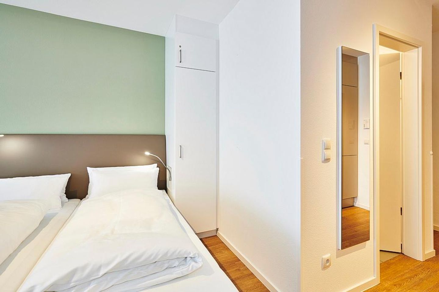 Deichhäuser Anna Küste Deichhäuser Anna Küste 2-12 Bensersiel - Wohn/Essbereich mit Doppelbett und Kleiderschrank