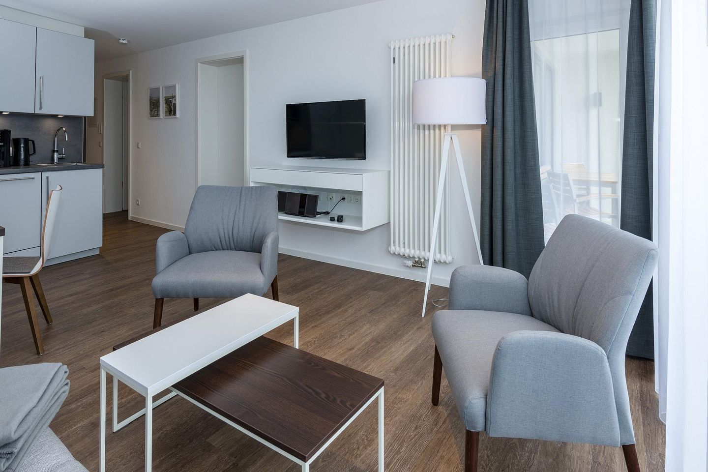 Deichhäuser Anna Küste Deichhäuser Anna Küste 6-34 Bensersiel - Wohn-Essbereich mit Couch, Sitzgelegenheit und Flatscreen TV