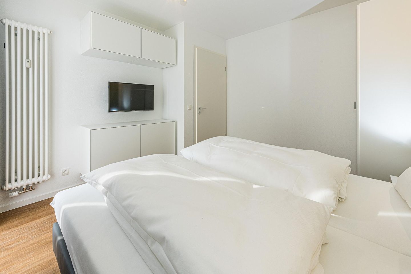 Deichhäuser Anna Küste Deichhäuser Anna Küste 7-10 Bensersiel - Schlafzimmer mit Doppelbett, Kleiderschrank und Flatscreen TV