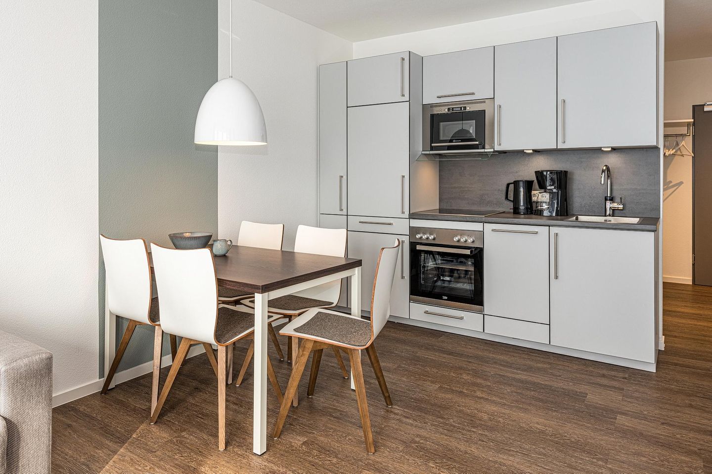 Deichhäuser Anna Küste Deichhäuser Anna Küste 7-14 Bensersiel - Wohn-Essbereich mit Esstisch, Sitzgelegenheit und Küchenzeile