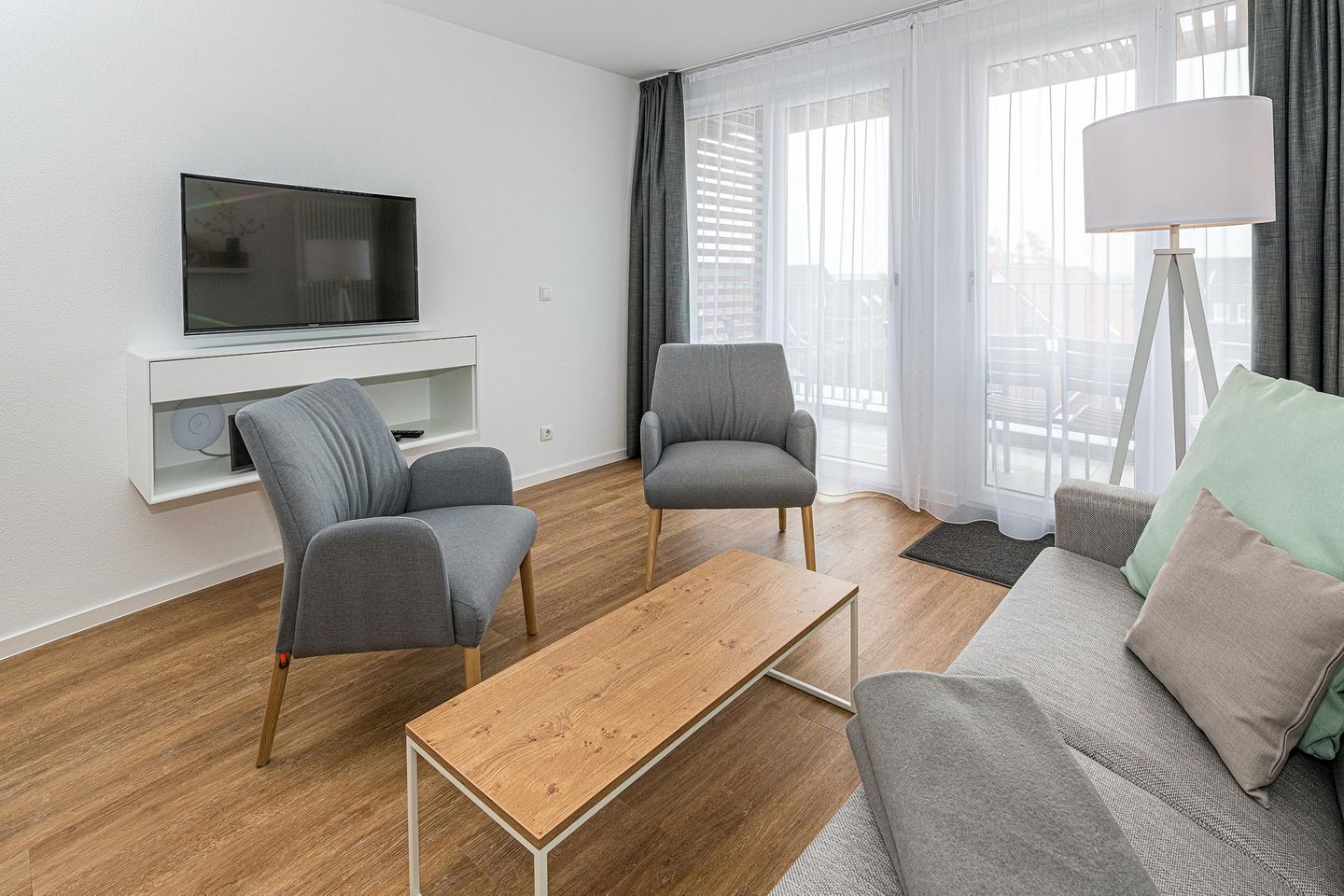 Deichhäuser Anna Küste Deichhäuser Anna Küste 7-30 Bensersiel - Wohn-Essbereich mit Couch