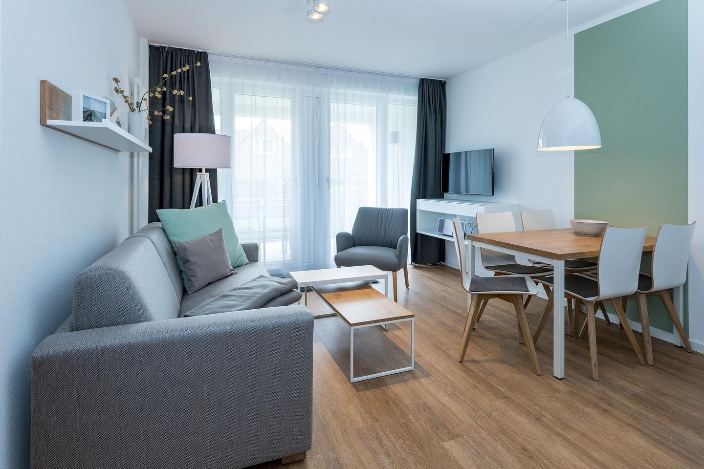 Deichhäuser Anna Küste Deichhäuser Anna Küste 8-11 Bensersiel - Wohn-Essbereich mit Couch