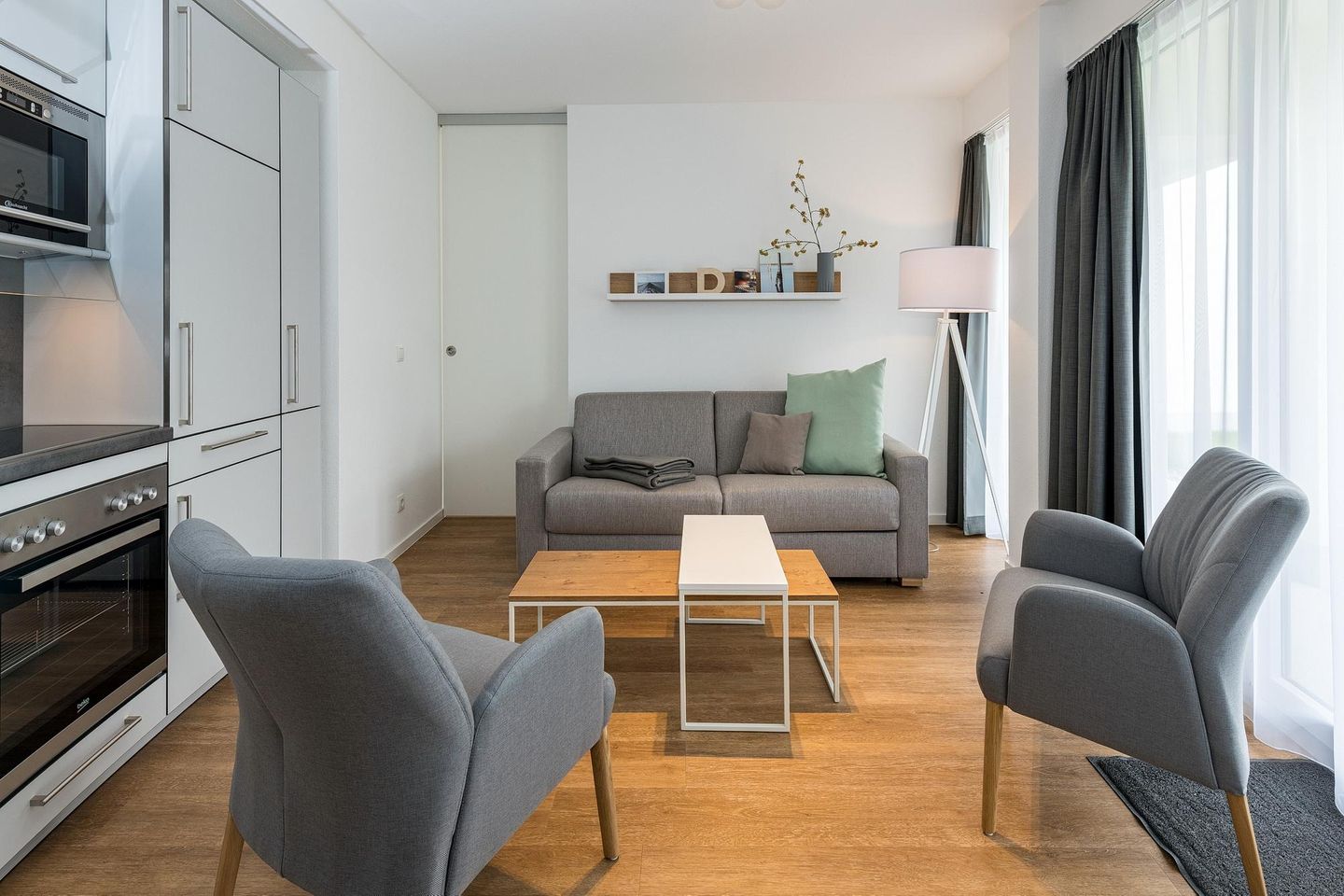 Deichhäuser Anna Küste Deichhäuser Anna Küste 8-13 Bensersiel - Wohn-Essbereich mit Couch