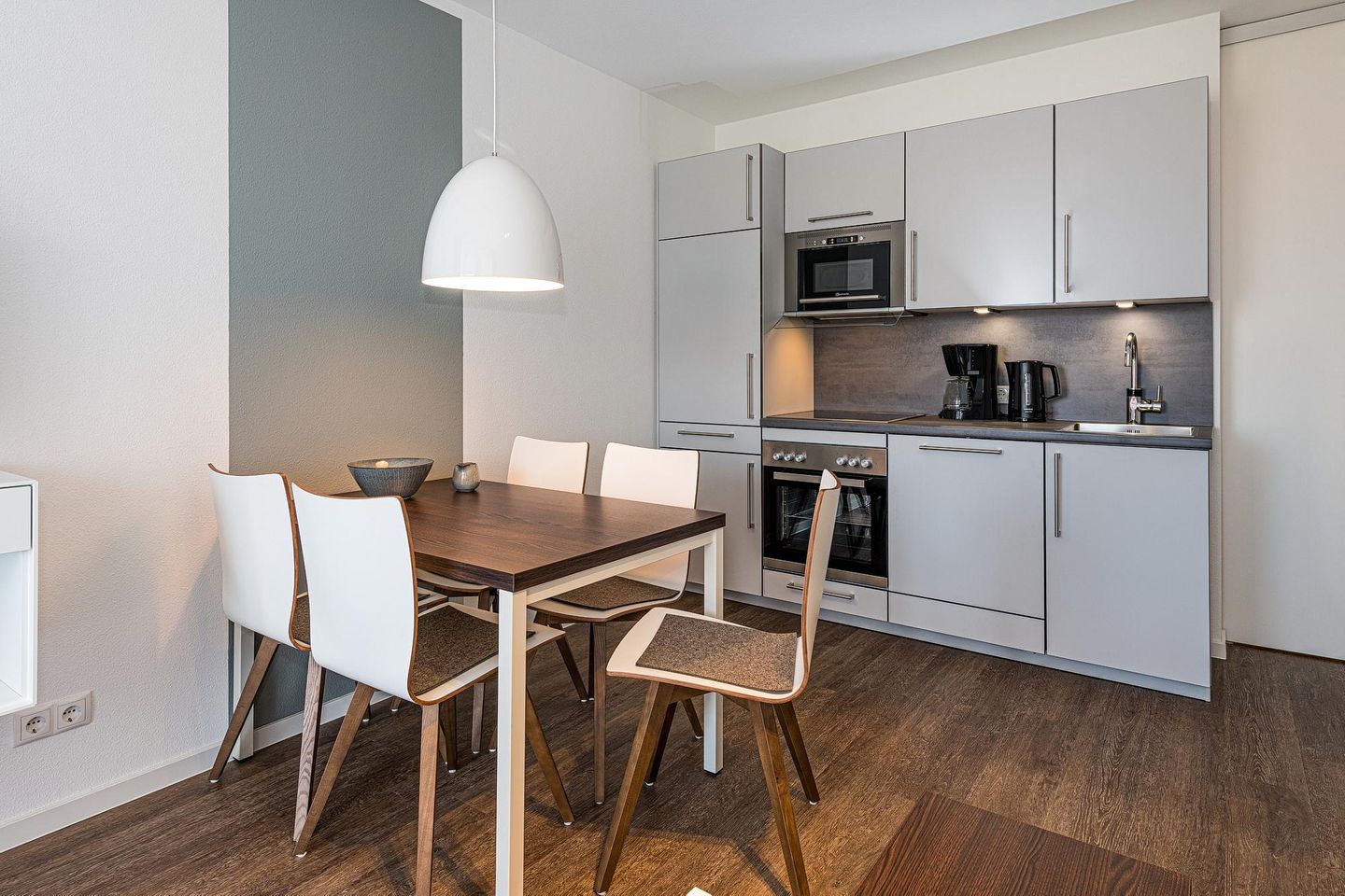 Deichhäuser Anna Küste Deichhäuser Anna Küste 8-21 Bensersiel - Wohn-Essbereich mit Esstisch, Sitzgelegenheit und Küchenzeile