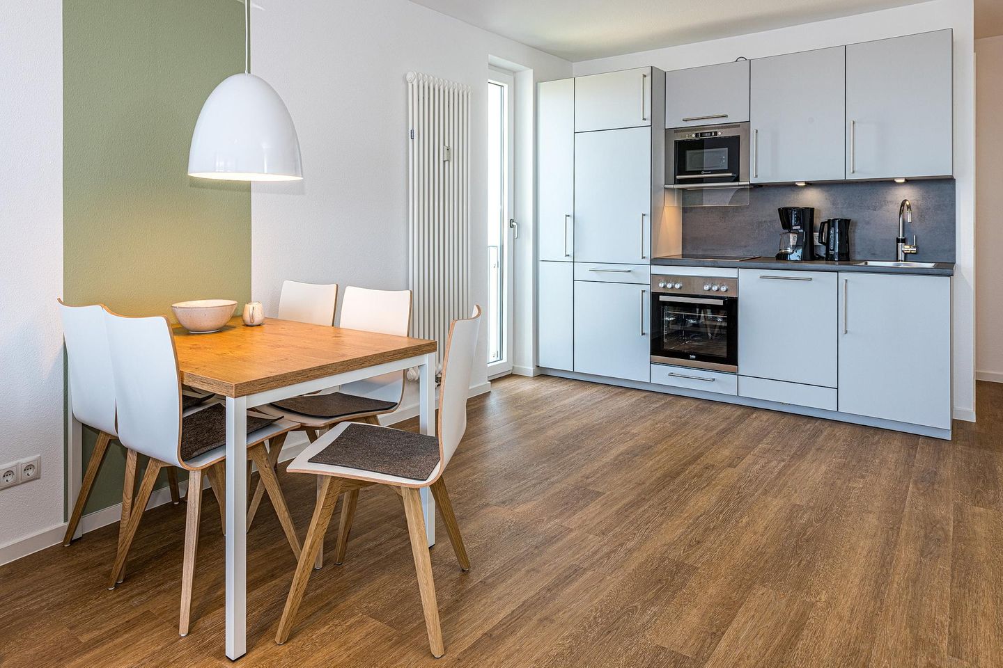 Deichhäuser Anna Küste Deichhäuser Anna Küste 8-30 Bensersiel - Küchenzeile mit Esstisch und Sitzgelegenheit