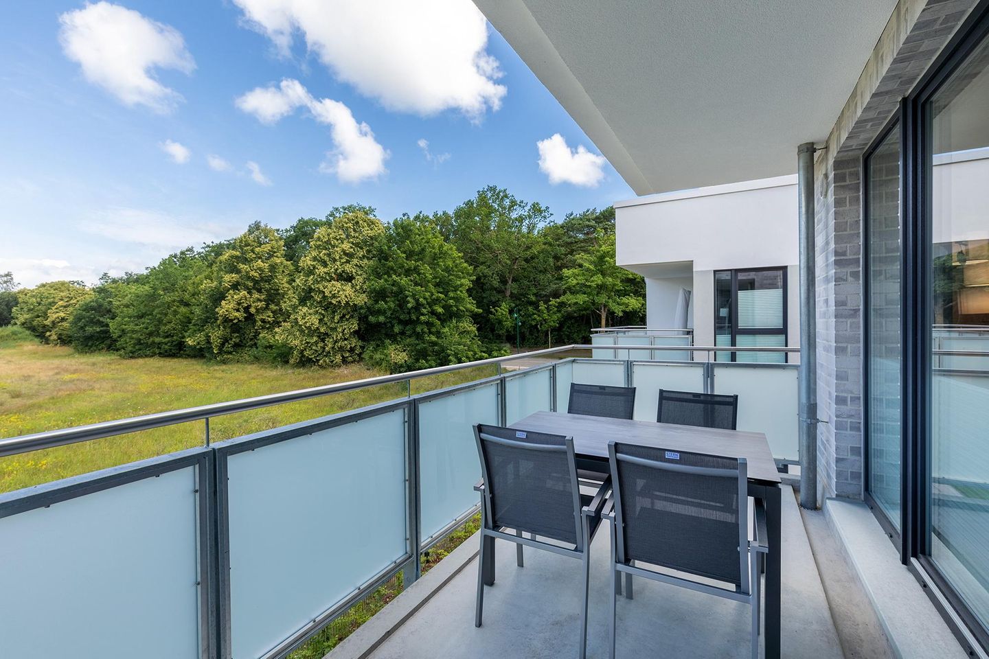 Aparthotel Ostseeallee Aparthotel Ostseeallee 2-15 Boltenhagen - Balkon mit Tisch, Sitzgelegenheiten und Blick ins Grüne