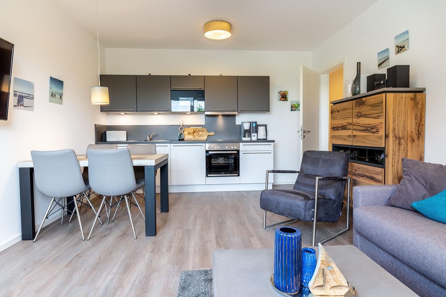 Aparthotel Ostseeallee Aparthotel Ostseeallee 3-24 Boltenhagen - Wohn-/Essbereich mit Doppelschlafcouch, Esstisch, Sitzgelegenheiten und Küchenzeile