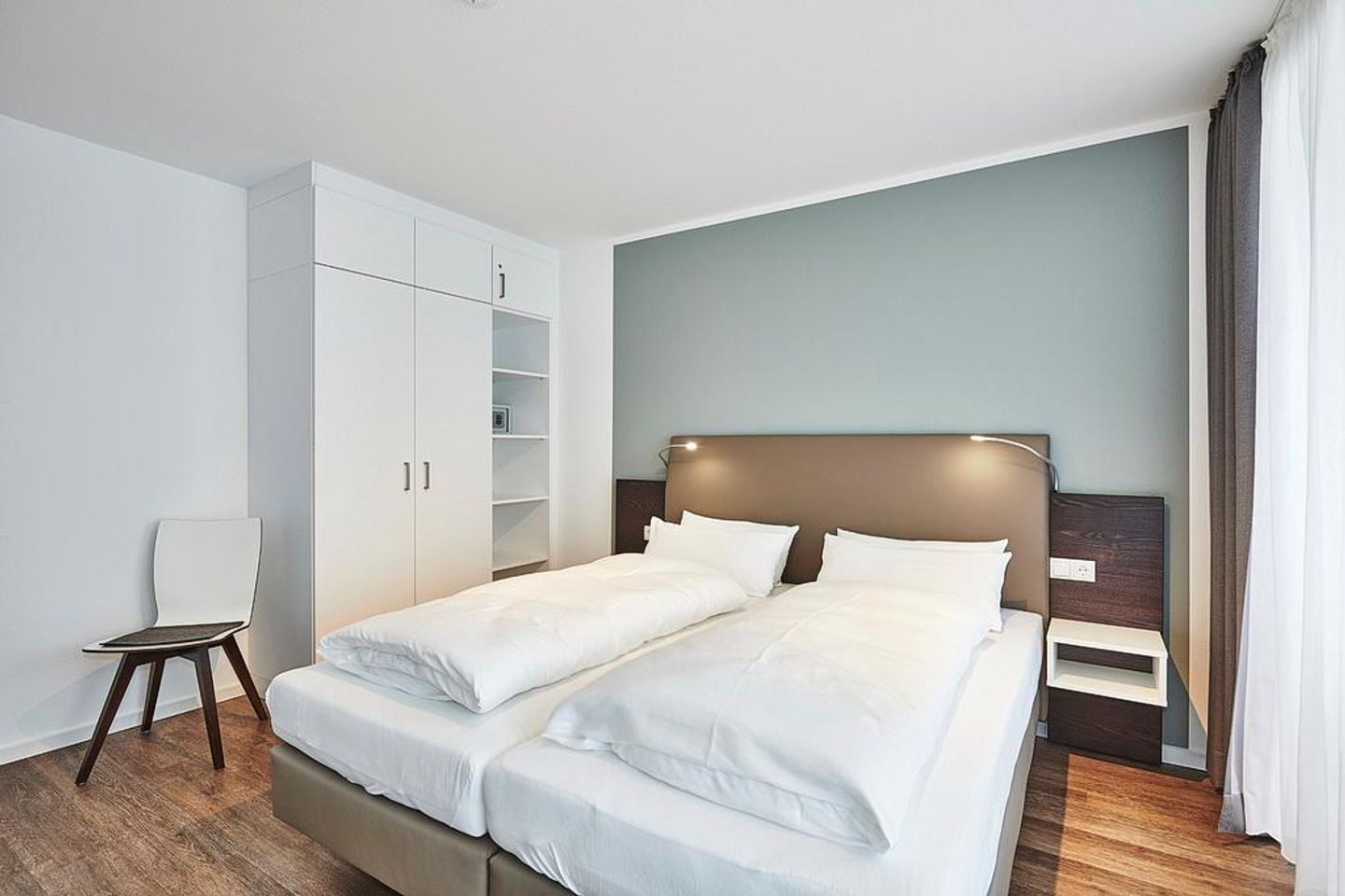 Deichhäuser Anna Küste Deichhäuser Anna Küste 2-34 Bensersiel - Schlafzimmer mit Doppelbett, Stuhl und Kleiderschrank