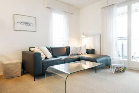 Cozy couch in the living room with access to the balcony Apartment Morgensonne