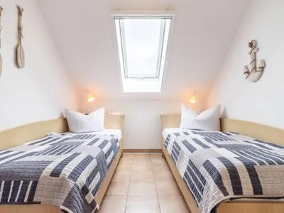 Schlafzimmer mit zwei Einzelbetten Residenz am Strand Wohnung 5-73