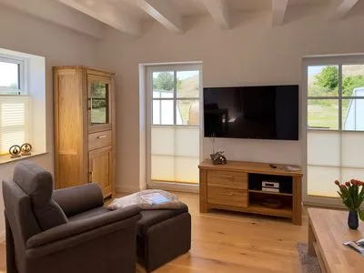 Wohnzimmer Haus Dünenperle Ferienwohnung "Dünengras"
