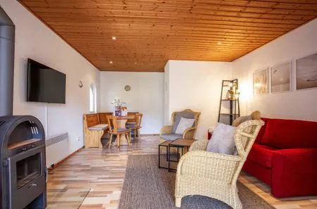 Ferienhaus MöwenKieker offener Wohnbereich mit Sitzecke und Kamin  MöwenKieker